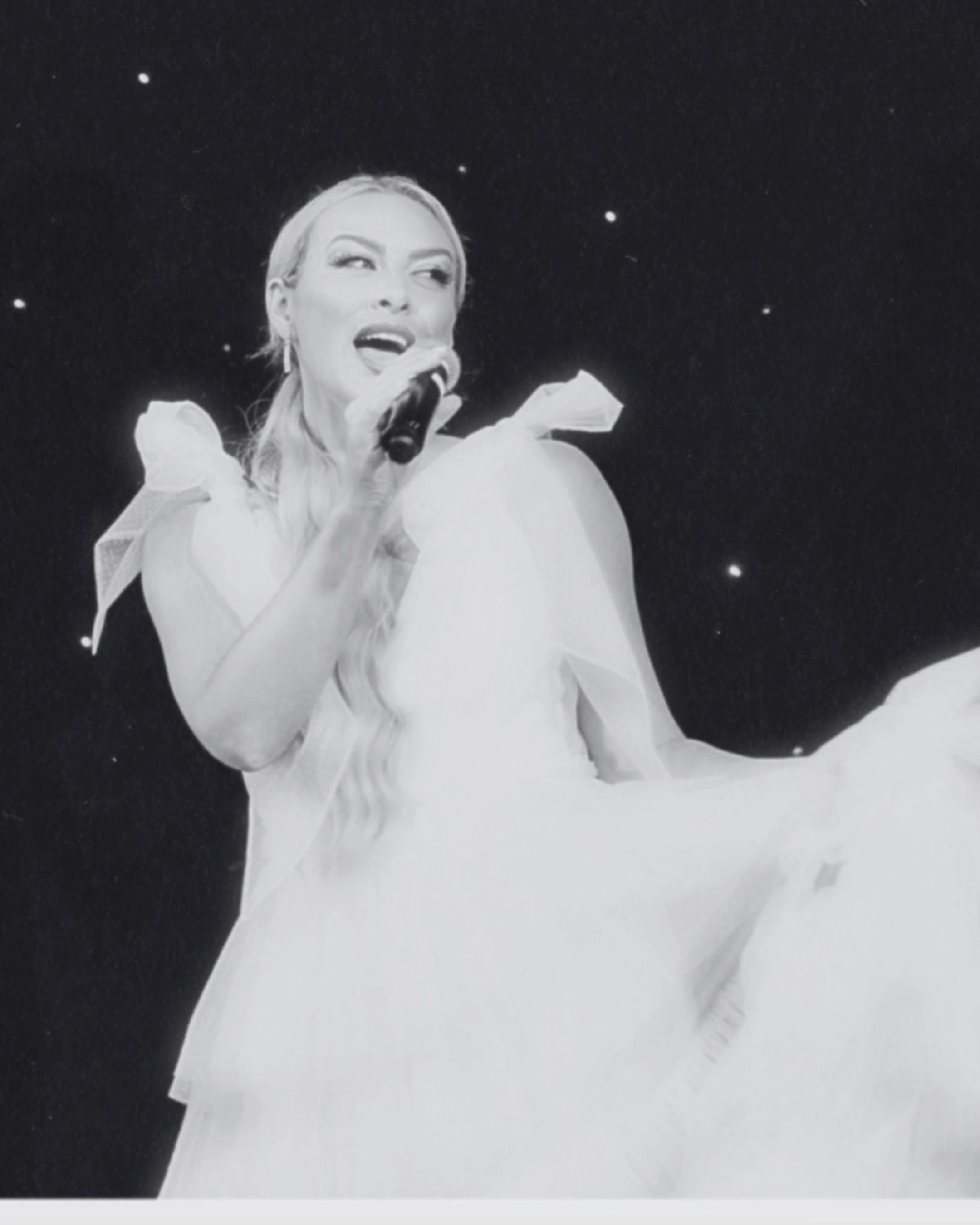 Emily Peacock performing live in a flowing gown