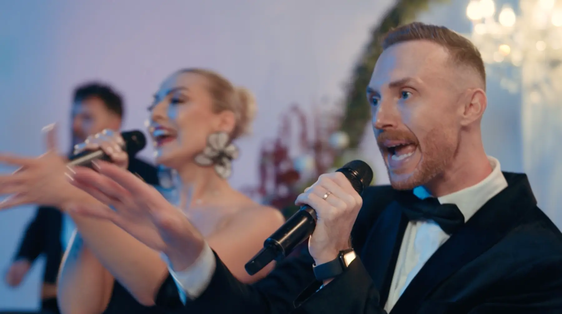 Male and female vocalists performing together