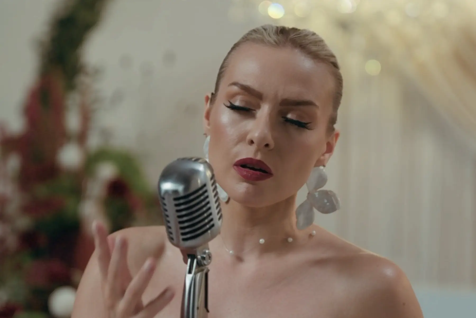 A close-up of Emily singing an intimate wedding ceremony performance