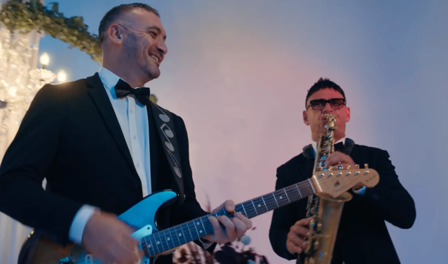 Guitarist and saxophonist representing a considered programme of live venue entertainment